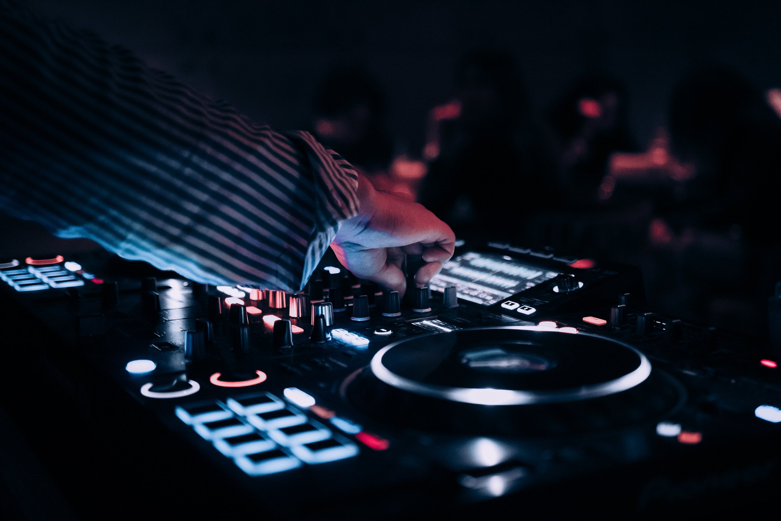 Close-up of DJ Mixing Music on a Console 